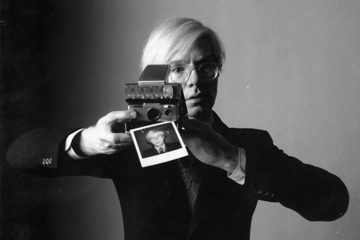 Andy Warhol with a Polaroid Camera